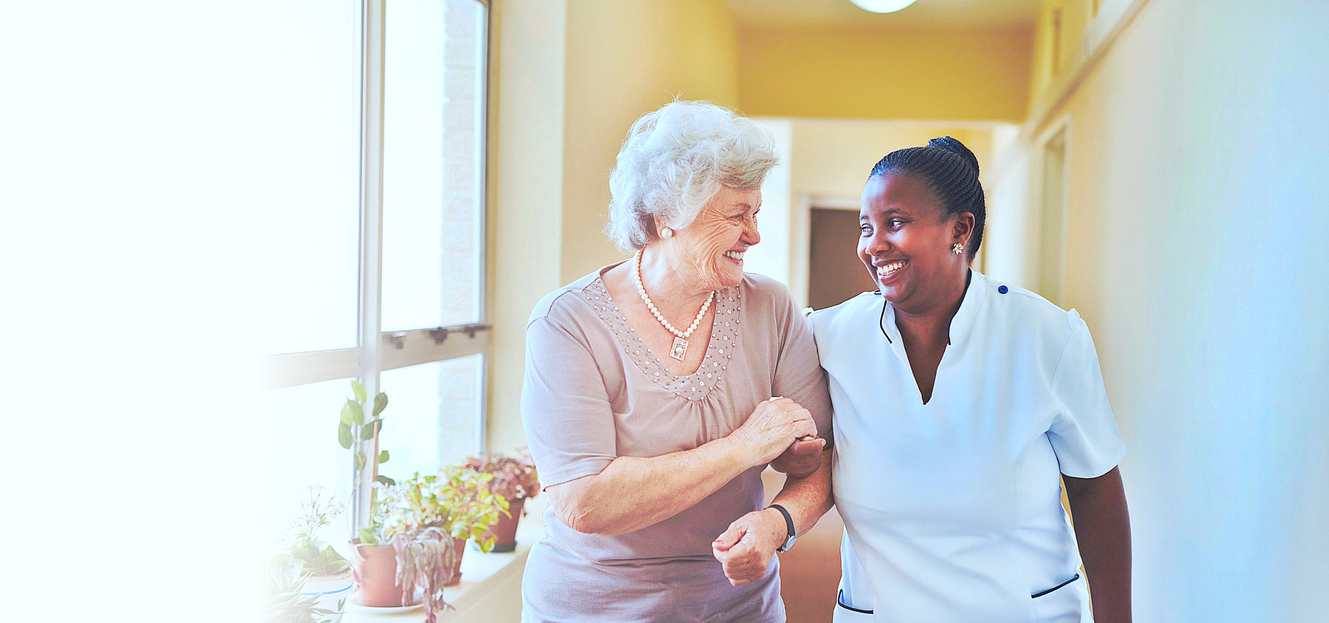 caregiver and senior woman smiling
