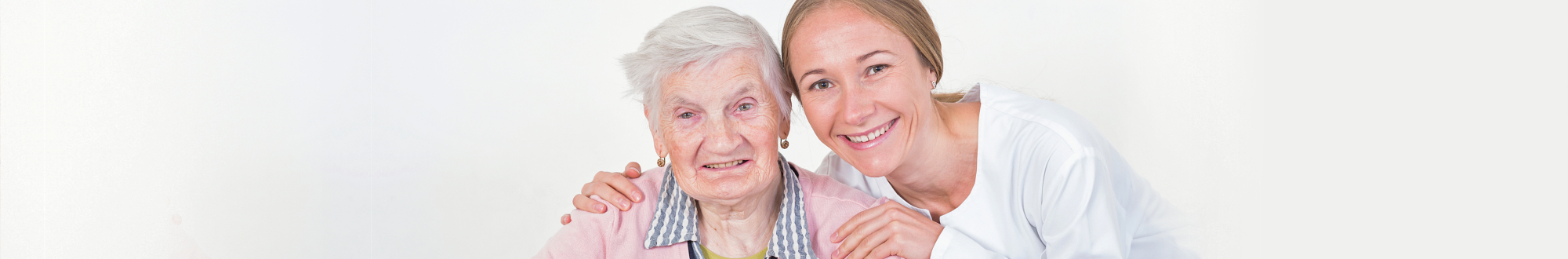 caregiver and senior woman smiling