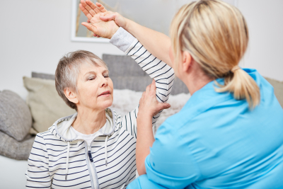 caregiver and elder woman doing occupational therapy