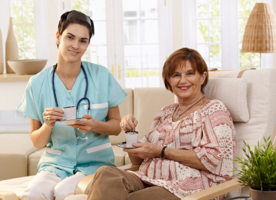 nurse and senior patient drinking coffee