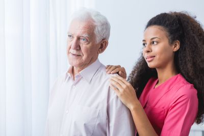 caregiver and elder man looking at something