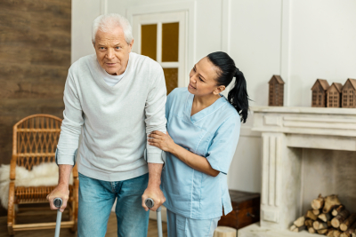 caregiver assisting elder man