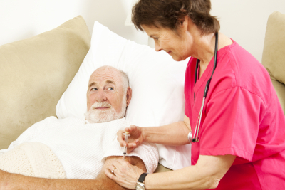 home health nurse giving a shot to an elder patient