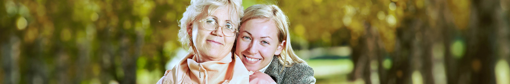 senior woman and caregiver smiling