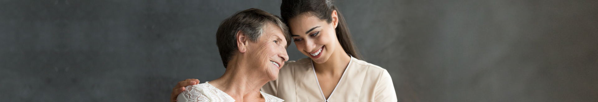caregiver and senior woman smiling
